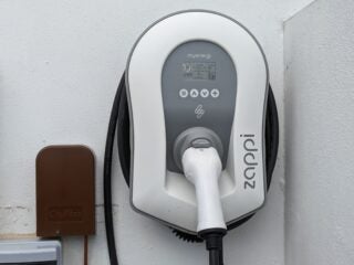 Photo of a white, tethered Zappi with the Type2 connector stowed