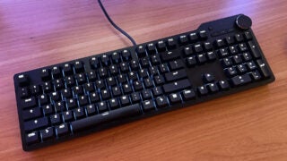 The Das Keyboard 6 Pro with white lighting sitting on a beech worktop.