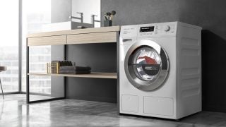 Miele WTH120 washer-dryer in a modern bathroom setting.